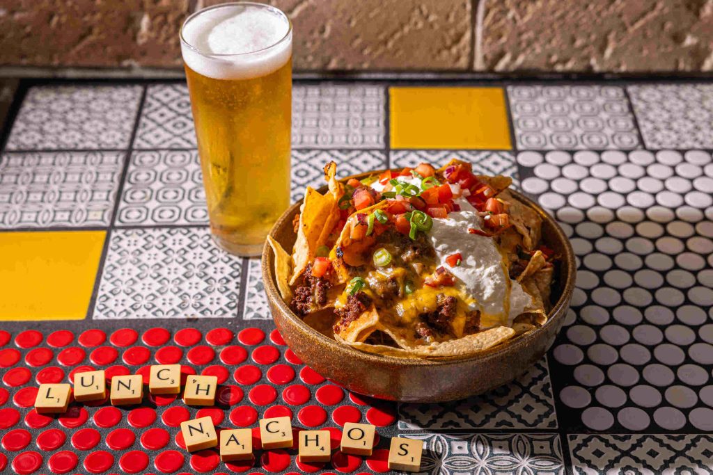 image of the mucho nachos grande with a beer